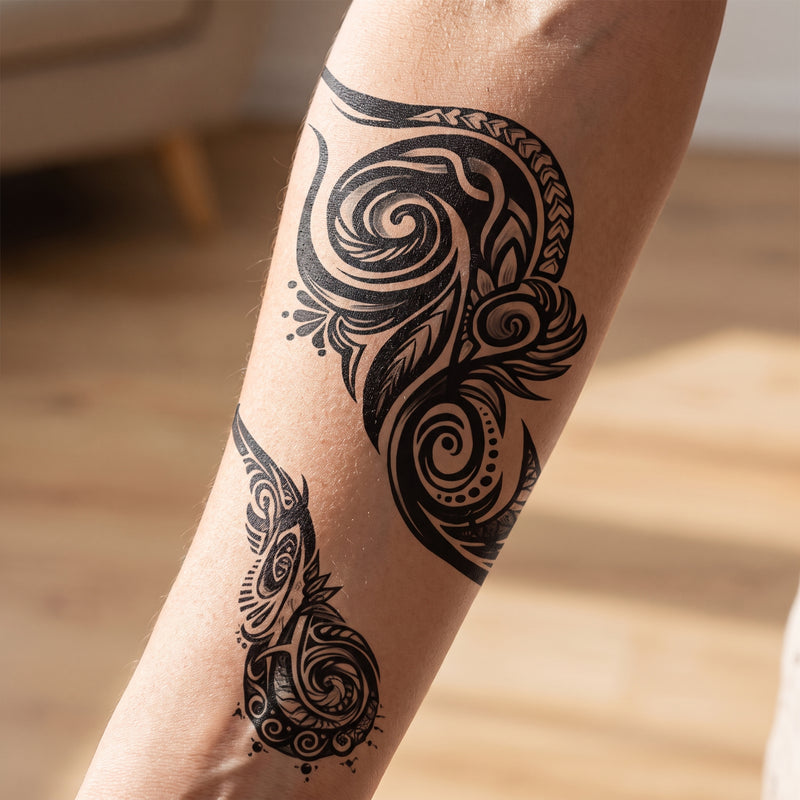 Black tribal swirl temporary tattoo worn on a forearm
