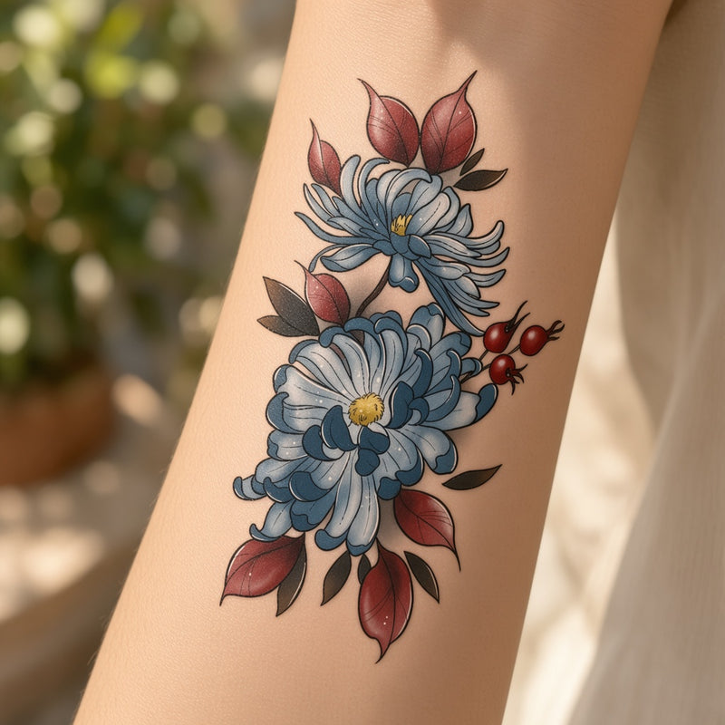 Blue chrysanthemum and rosehip temporary tattoo worn on the forearm