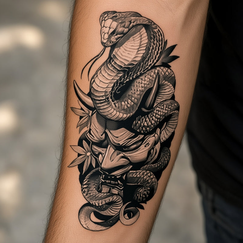 Cobra coiled over a demon mask worn on an outer forearm, black and white temporary tattoo design